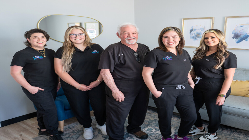 The Jewell Wellness Center team in black scrubs with Medical Director Dr. Dan Butler at the Denham Springs clinic
